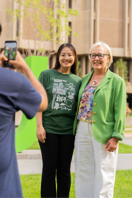 President Bloomberg taking a picture with a student.