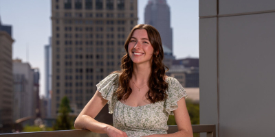 Sarah McCartney posing in front of Cleveland skyline