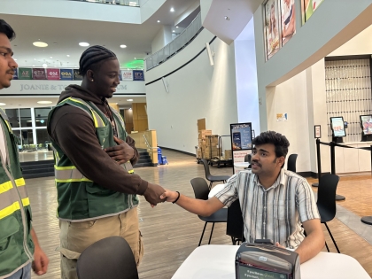Viking safety ambassador shaking the hand of a student outside of Chick-Fil-A