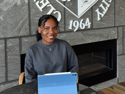 female student at table with laptop