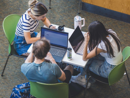Three students studying at a table