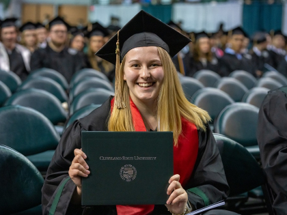 Female undergrad holding her diploma
