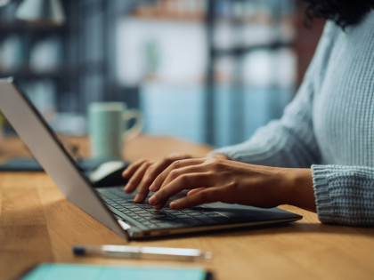 Picture of woman working on a laptop.